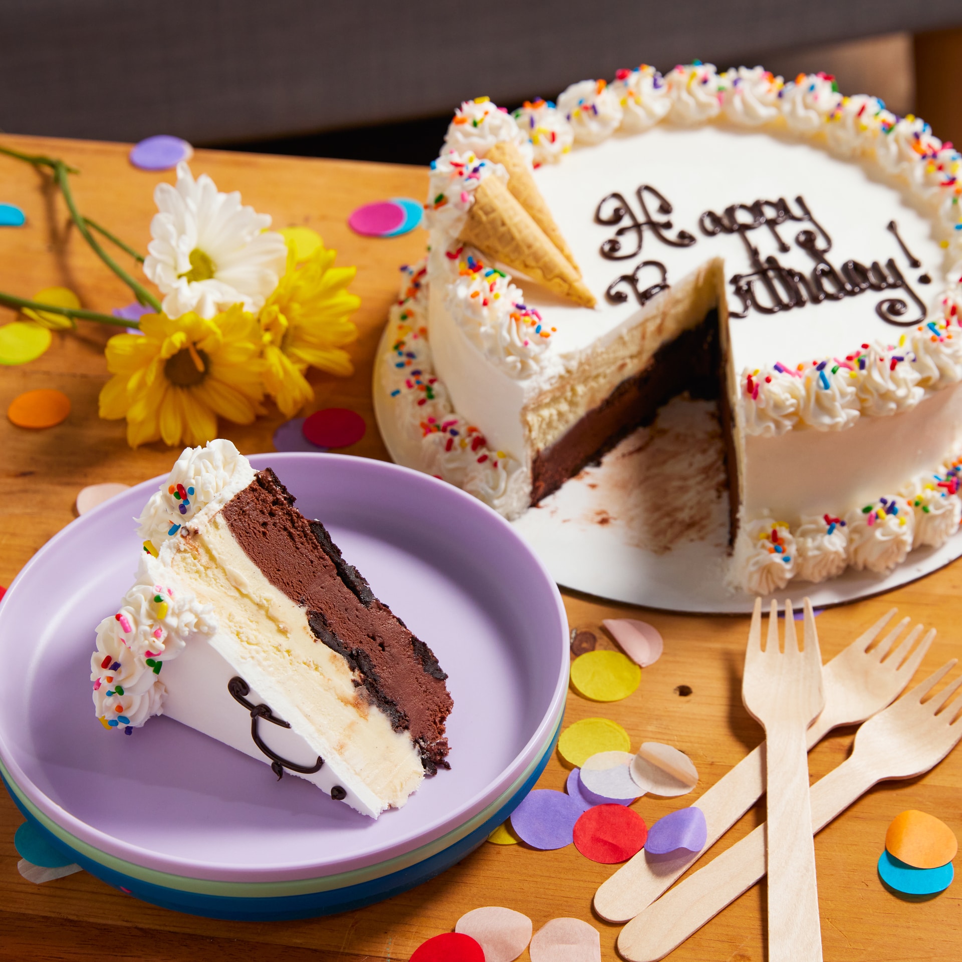 Ice cream cake on a table with party supplies